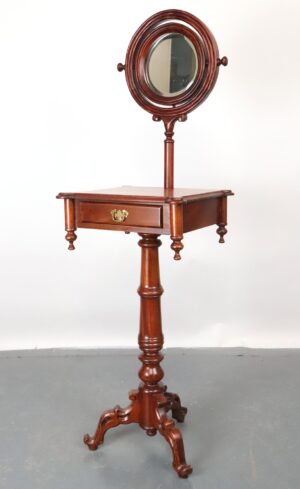 Victorian-style wooden shaving stand with a tilting beveled mirror, single drawer with brass hardware, and a four-leg base.