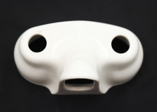 White ceramic tub faucet cover with two top handle openings and a central front spout opening, shown close up.