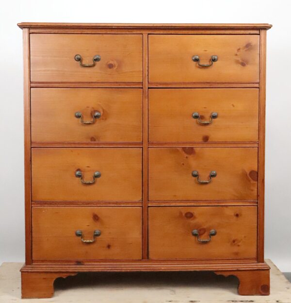 Traditional eight-drawer dresser with a medium wood tone, brass pulls, and a double-sided design showing four drawers on each side.