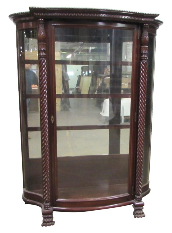 Spanish Revival curio cabinet with curved glass panels, dark wood tone, and twisted front columns, shown from the front with a single door and claw feet visible.