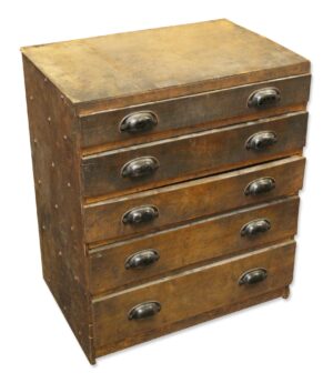 Vintage industrial workshop chest of drawers with five drawers and steel bin pulls, shown in dark wood tone with heavy surface wear and staining.