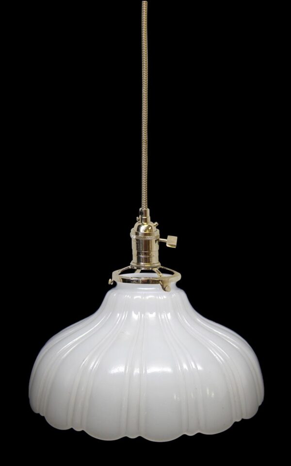 Milk glass pendant light with a fluted white shade and polished nickel fitter, shown in a close-up from below.