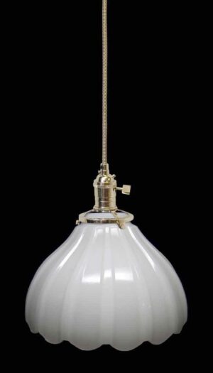 Pendant light with a fluted milk glass shade and polished nickel fitter, shown hanging from a braided cord.