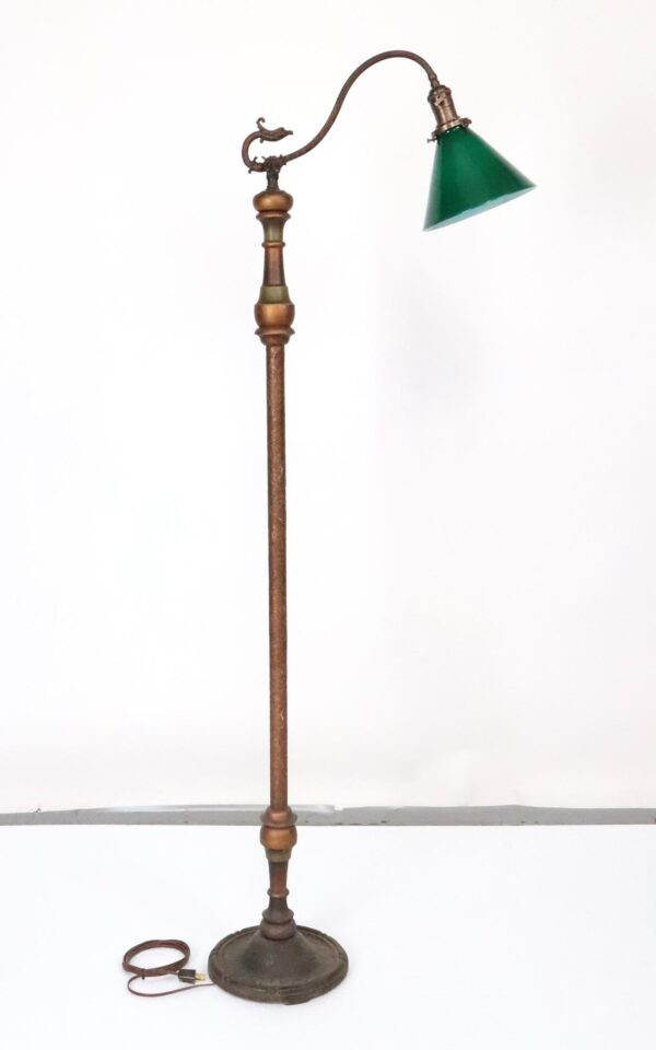 Victorian bridge floor lamp with a green glass shade, ornate curved arm, and a tall brass and cast iron base.