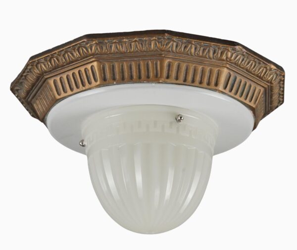 Neoclassical flush mount fixture with a bronze-toned molded fitter, a broad white dish, and a fluted milk glass bowl.