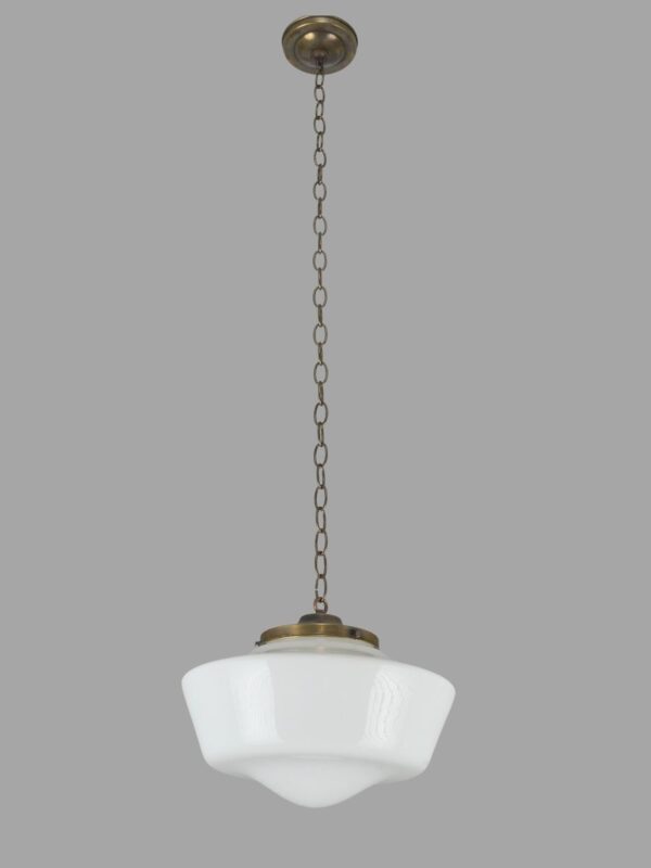 Schoolhouse pendant light with a white milk glass globe and antique brass chain and canopy.