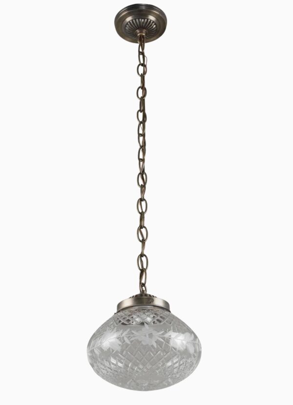 Traditional pendant light with a clear etched glass globe and antique brass chain fitter, shown hanging from the ceiling mount.