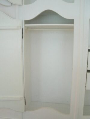 White built-in cabinet doors with a curved French-style top panel are shown in a close-up view.