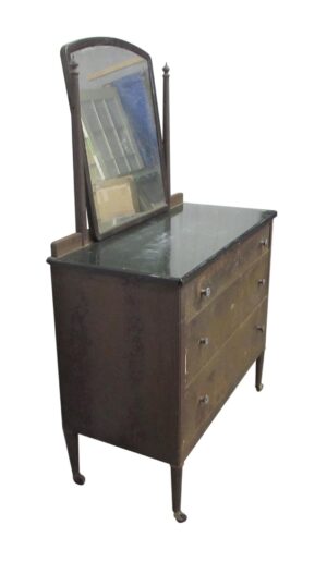 Vintage steel dresser with framed mirror, three drawers, and caster feet shown at an angle.