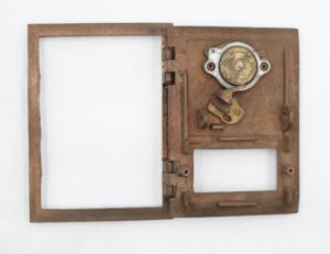 Vintage bronze post office box door shown open, with a combination dial and eagle emblem on the inner panel and a large rectangular opening on the left.