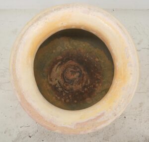 Top view of a Biot olive jar with a rounded rim and weathered interior.