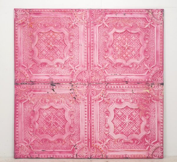 Handcrafted pink ornate tin wall panel with four quadrants and raised decorative detailing.