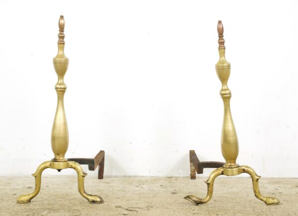 Pair of Federal brass fireplace andirons with a steeple design, shown as a pair and including one bent leg.