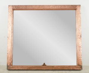 Copper window frame mirror with a polished frame and mounting wire attached at the bottom.