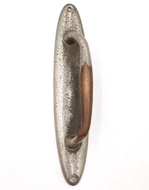 Vintage oval door pull with a curved handle and worn nickel-plated brass finish, shown front on.