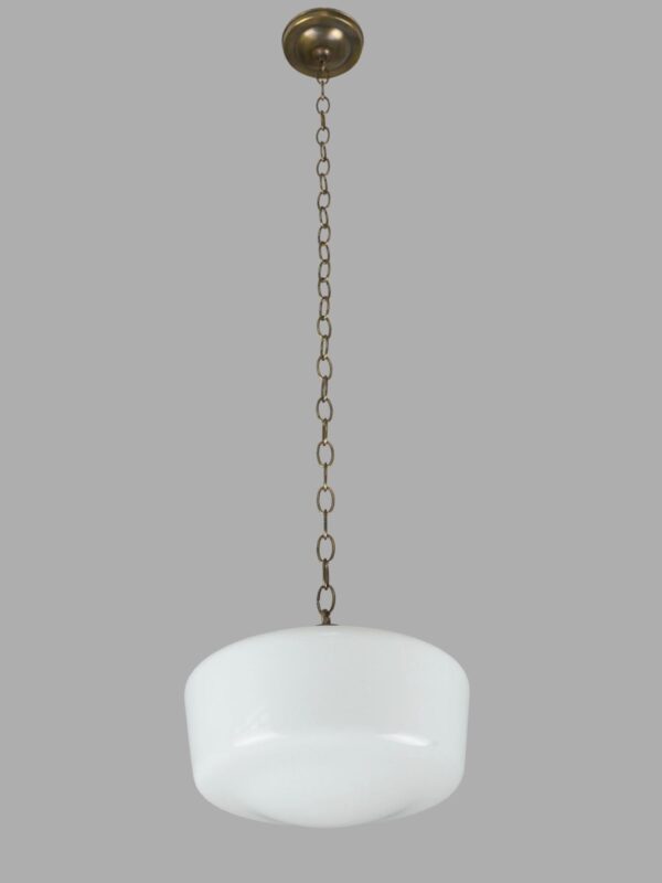 Schoolhouse pendant light with a white milk glass globe and an antique brass chain fitter.