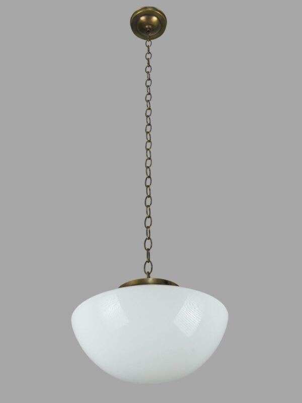 Schoolhouse pendant light with a white milk glass globe and antique brass chain fitter.