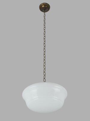 Schoolhouse pendant light with a milk glass globe and antique brass chain fitter.