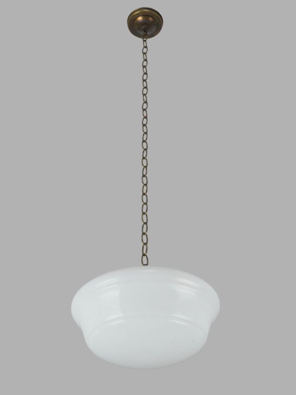 Schoolhouse pendant light with a white milk glass globe and an antique brass chain fitter.