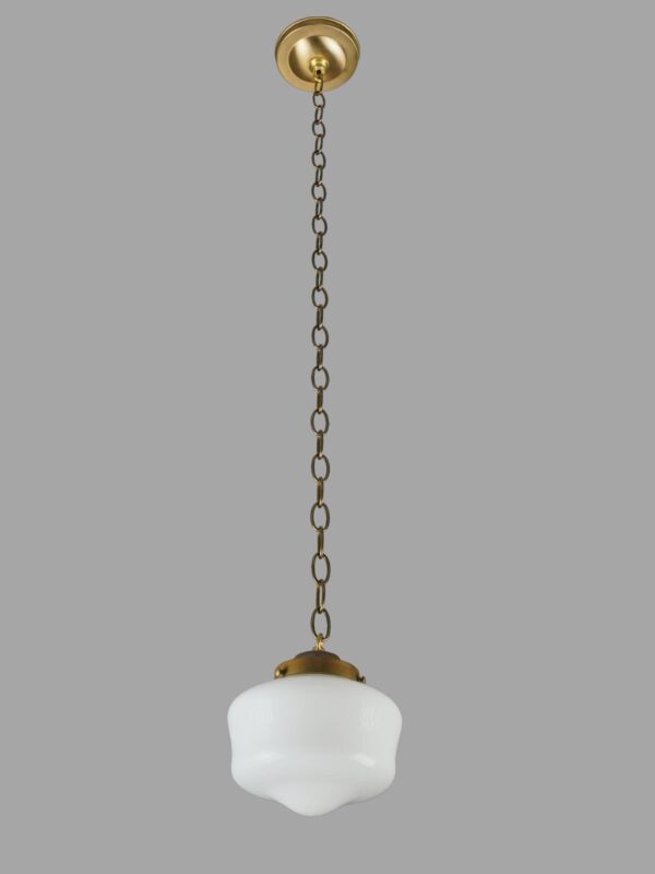 Schoolhouse pendant light with a milk glass globe and antique brass chain fitter.