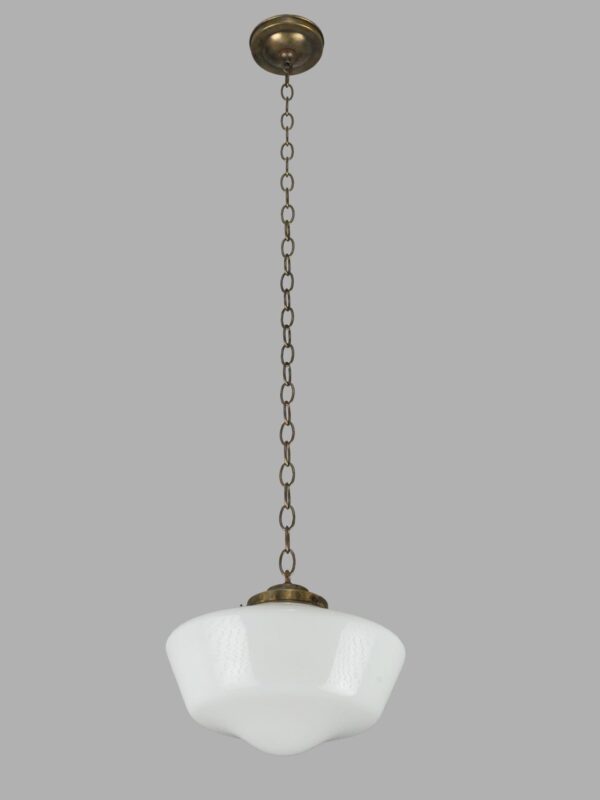 Schoolhouse pendant light with a white milk glass globe and antique brass chain fitter.
