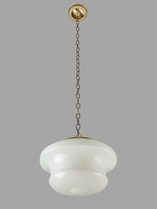 Schoolhouse pendant light with a milk glass globe and antique brass chain fitter, shown hanging from a round canopy.