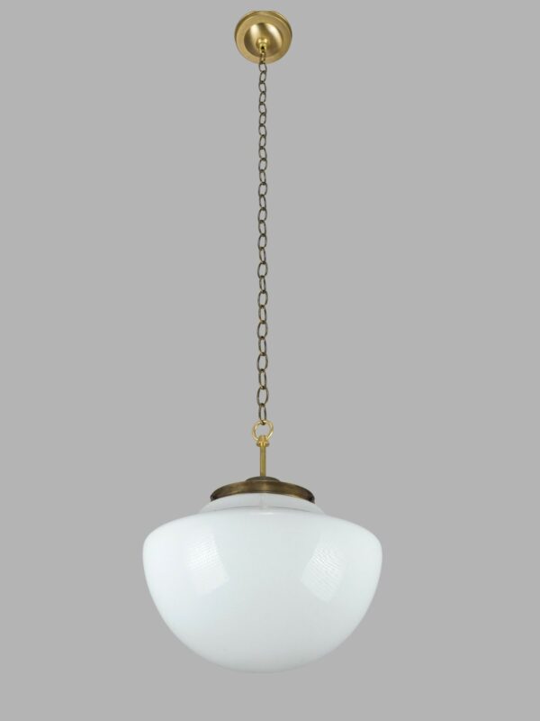Schoolhouse pendant light with a white milk glass globe and an antique brass chain fitter.