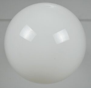 White glass globe pendant light shown in a straight-on close-up of the rounded shade, with only a small portion of the fitter visible.