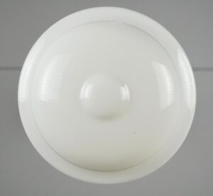 Schoolhouse pendant light with a milk glass globe and round white shade visible from below.