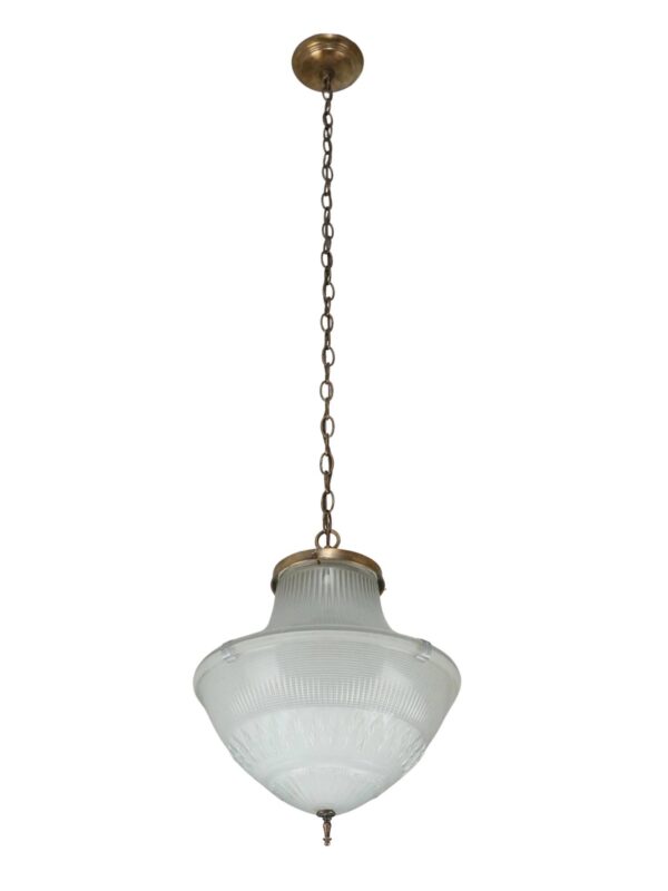 Industrial pendant light with a white glass globe, antique brass chain fitter, and hanging chain.
