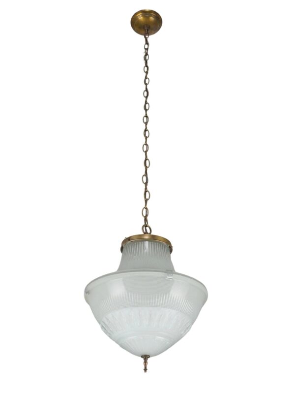Industrial pendant light with a white globe shade, antique brass chain, and a pointed finial.