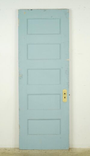 Vintage blue wood passage door with five panels and an antique brass lock plate.
