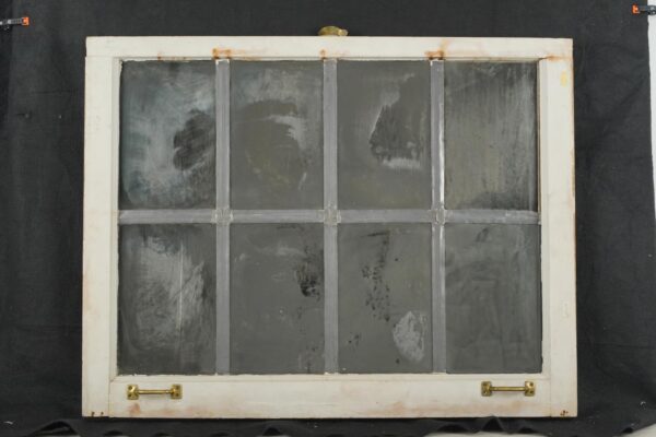 Reclaimed wood window mirror with eight panes, worn silvering, and original brass hardware on the bottom rail.