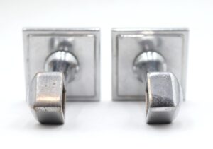 Pair of Art Deco towel bar brackets with a nickel finish, shown as a front view of the matching pair with visible mounting plates and surface wear.