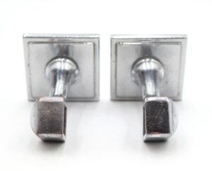 Pair of Art Deco towel bar brackets in nickel-plated brass, shown as a matching set with visible surface wear.