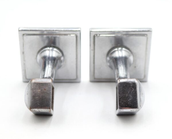 Pair of Art Deco towel bar brackets in nickel-plated brass, shown as a matching set with visible surface wear.