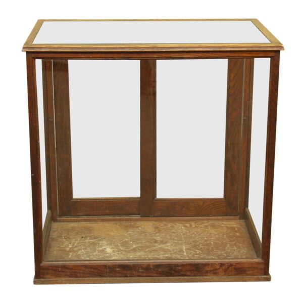 Glass-walled oak showcase with two sliding doors at the back and a worn base interior.