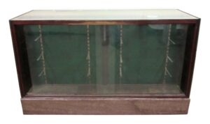 Display showcase with glass sliding doors and a marble plinth, shown from the front with the cabinet interior visible through the glass.