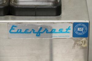 Close-up of a vintage Everfrost ice cream machine showing the front label and NSF testing sticker on the stainless steel cabinet.