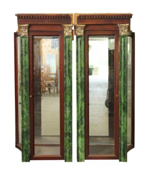 Pair of built-in display cabinets with glass doors, faux malachite pillars, and mirrored panels.