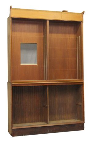 Medium wood tone wooden display cabinet with two open sections, built-in shelving supports, a cutout in the upper left back panel, and visible surface wear from prior use.