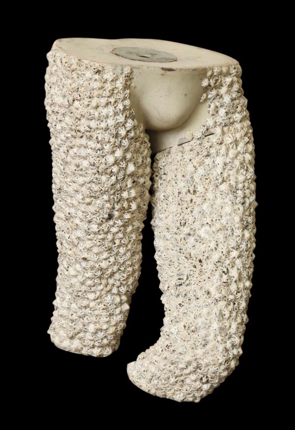 White plastic mannequin torso with a barnacle-like textured surface and split leg forms, shown from the front.