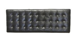 Black tufted leather bench cushion shown from above, with a rectangular shape and visible surface wear.