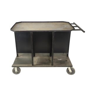 Black steel service cart with six covered sections, a push bar, and four caster wheels, shown in a front view with visible surface wear.