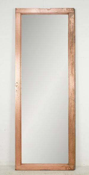 Tall mirror made from a copper window frame with a simple rectangular profile and polished finish.