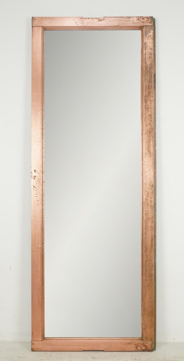 Tall mirror made from a copper window frame with a simple rectangular profile and polished finish.
