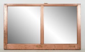 Double-sided mirror in a salvaged copper window frame with two panes and a mounting wire attached on the back.