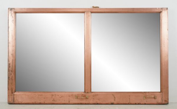Double-sided mirror in a salvaged copper window frame with two panes and a mounting wire attached on the back.