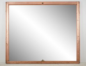 Large copper-framed mirror with a rectangular window-style design and a small latch at the bottom center.