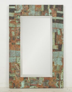 Rectangular wall mirror with a patchwork copper frame and beveled inner edge.